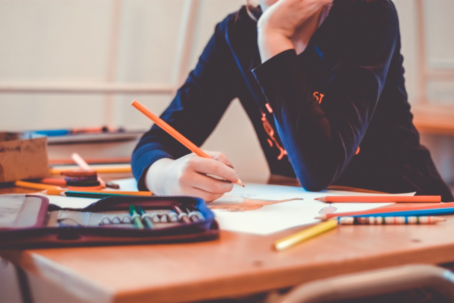 Person Drawing on a Desk